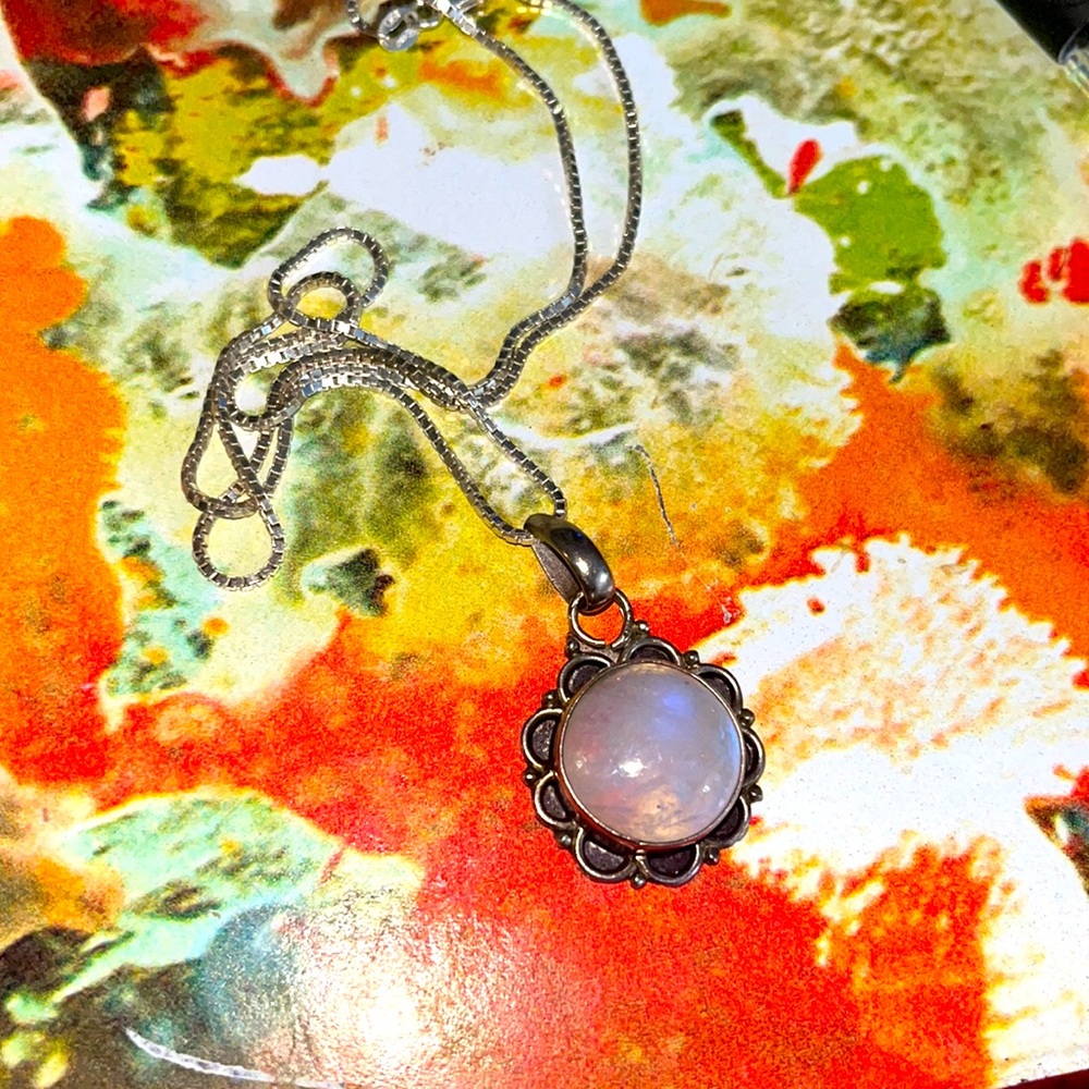 Moonstone pendant on silver chain.